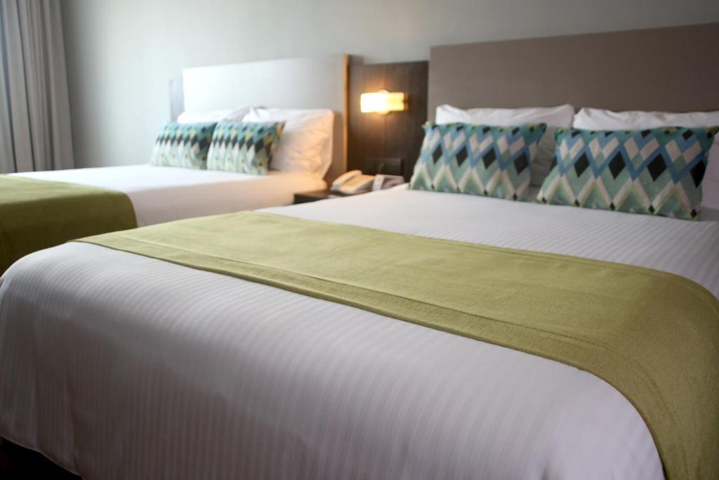 Postel nebo postele na pokoji v ubytování Aranjuez Hotel & Suites