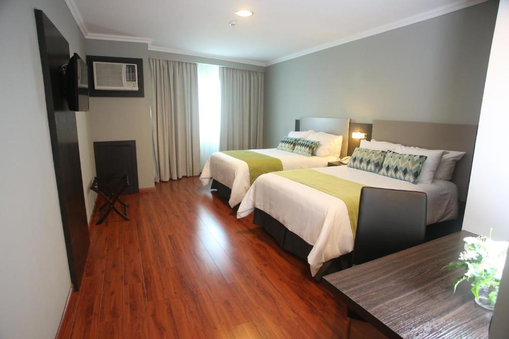 Postel nebo postele na pokoji v ubytování Aranjuez Hotel & Suites