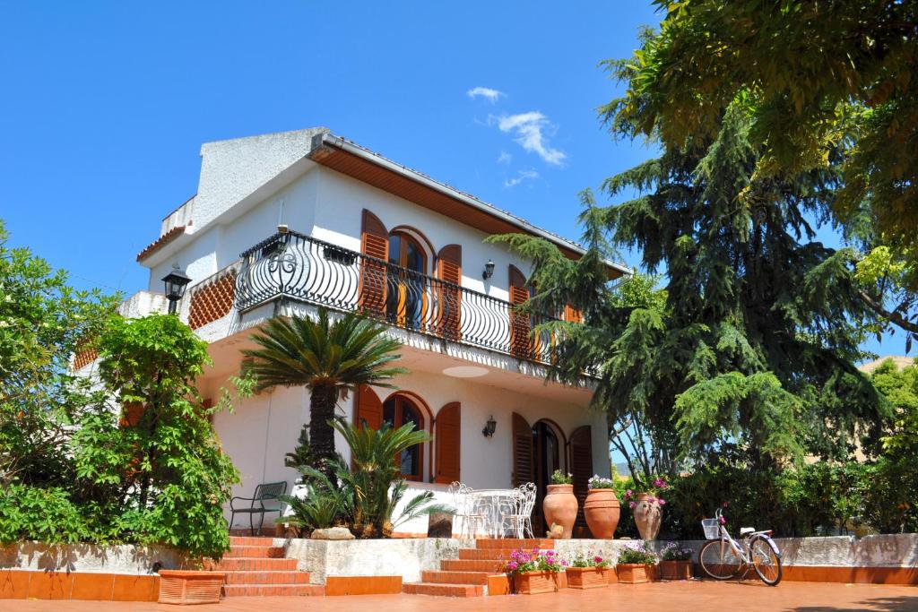 a white house with a staircase in front of it at Villa Bea in Giardini Naxos