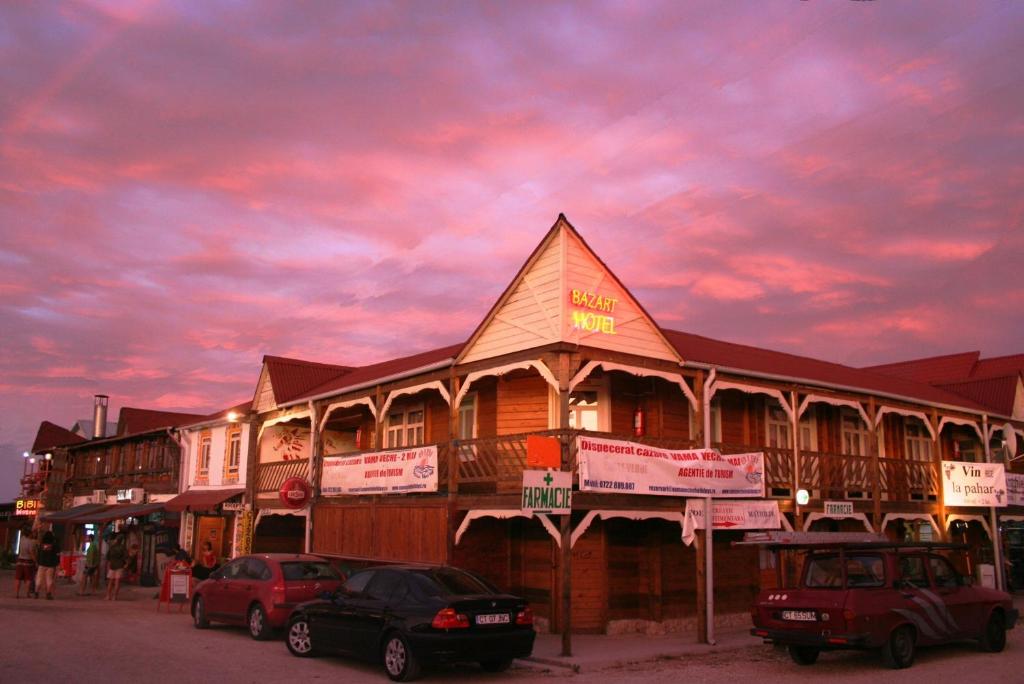 a building with cars parked in front of it at Bazart Vama Veche in Vama Veche