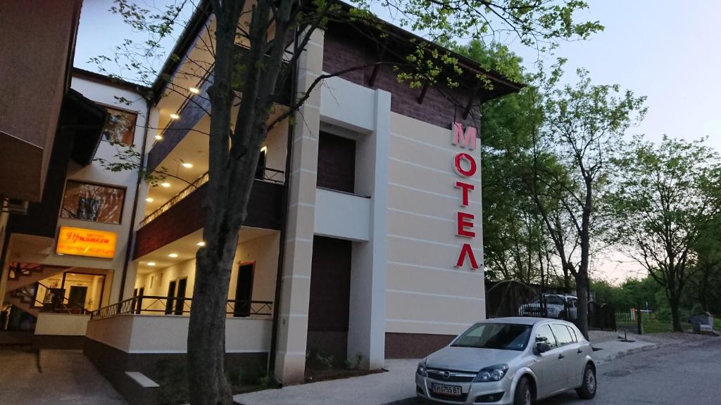 a car parked in front of a building at Complex Friends in Pleven