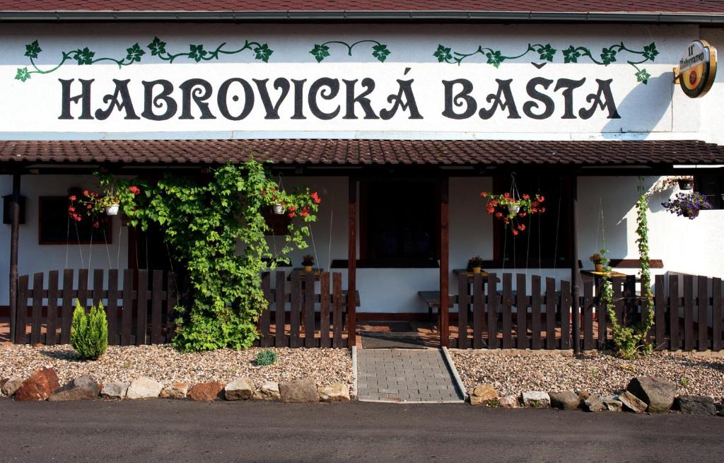 a restaurant with a sign on the front of a building at Penzion Habrovická Bašta in Ústí nad Labem