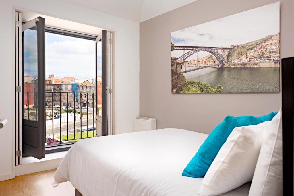 a hotel room with a bed and a window at Oldcity Design Apartments in Porto