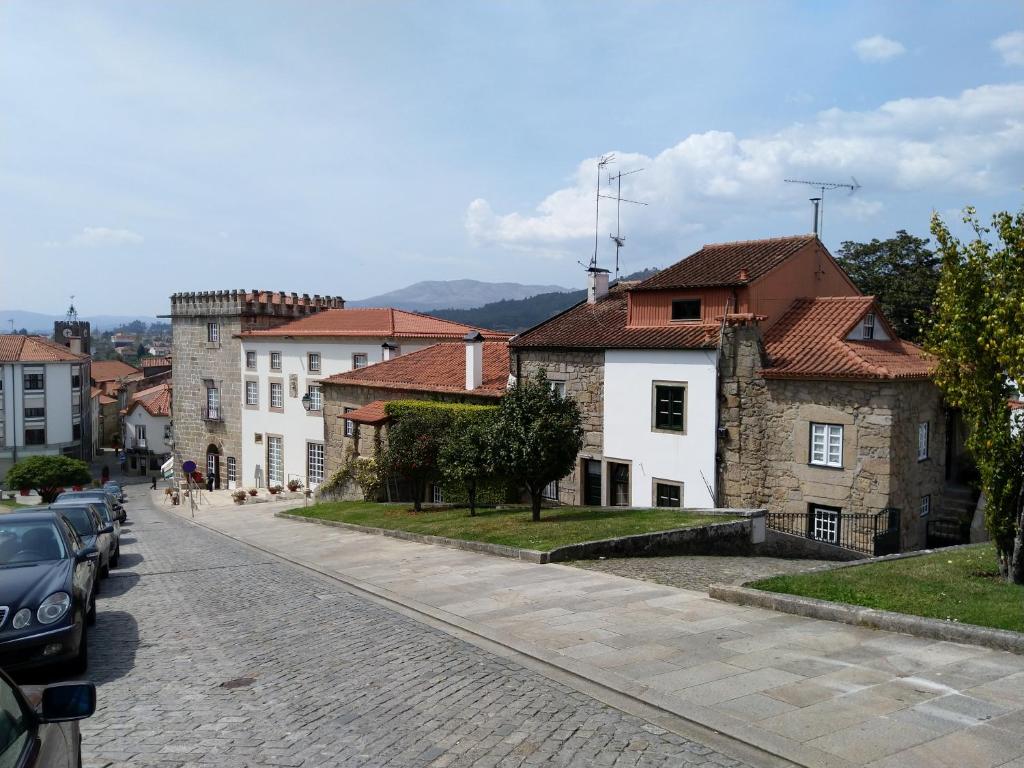 a cobblestone street in a town with buildings at Casa das Neves in Ponte de Lima