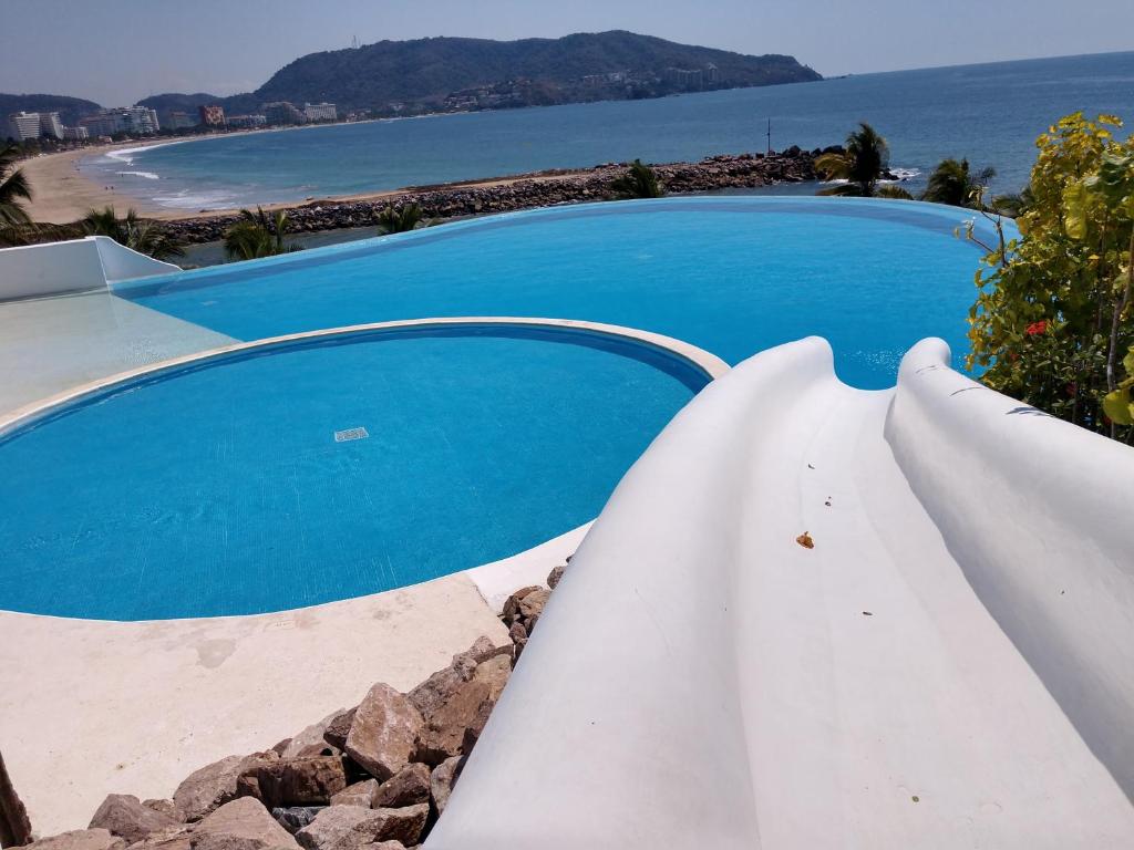 Bazén v ubytování Ixtapa frente al mar nebo v jeho okolí