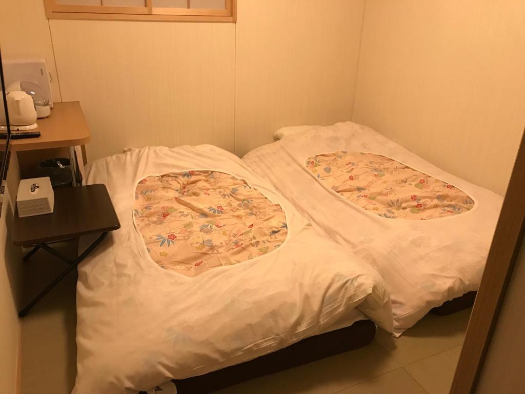 Postel nebo postele na pokoji v ubytování Hotel Famitic Nikko Station