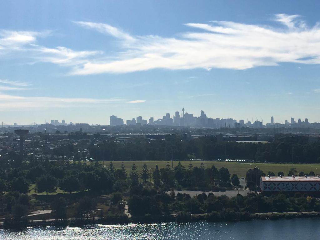 a view of the city from the lake at Panoramic views in luxurious brand new apartment in Sydney