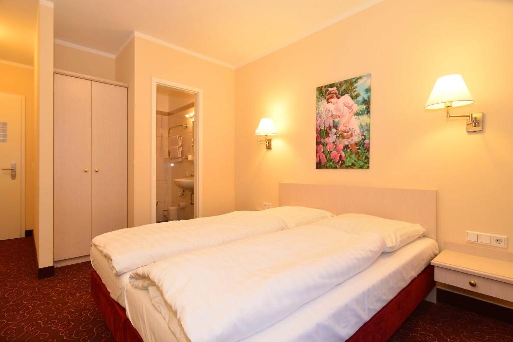 Postel nebo postele na pokoji v ubytování Hotel Behrmann