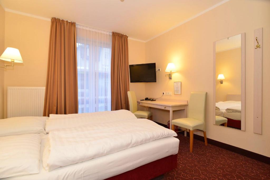 Postel nebo postele na pokoji v ubytování Hotel Behrmann