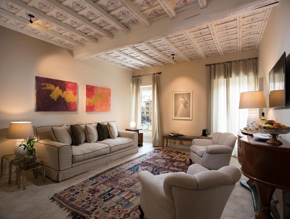 a living room with a couch and chairs in it at Palazzo Caruso in Rome