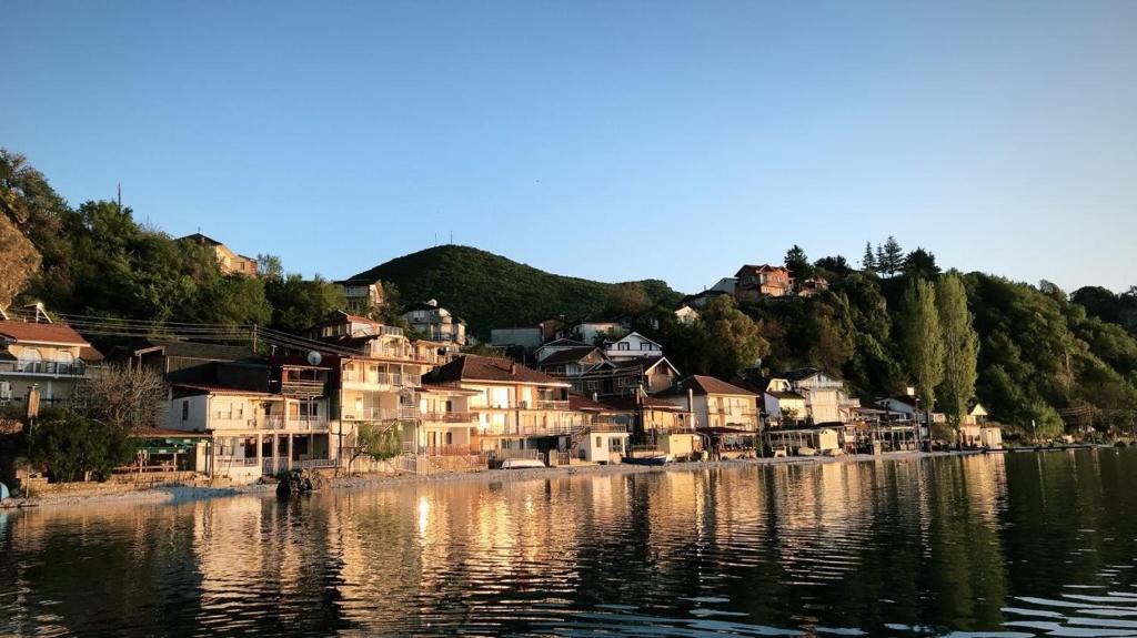 a group of houses on the shore of a river at Rooms and Apartaments De Niro in Trpejca