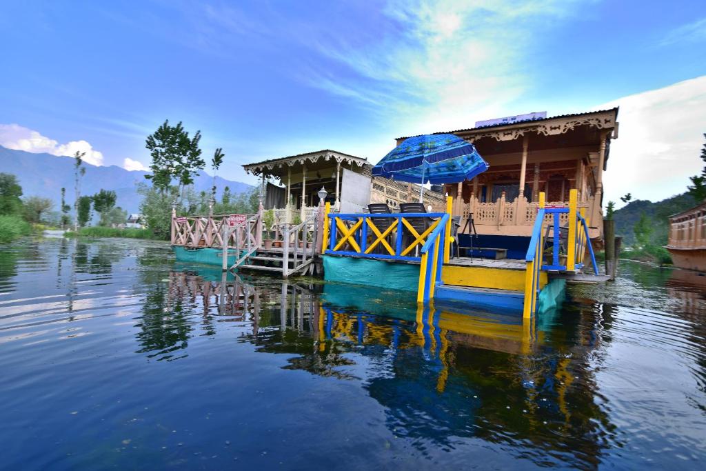 a yellow and blue boat on the water at Golden Hopes Group of Houseboats in Srinagar