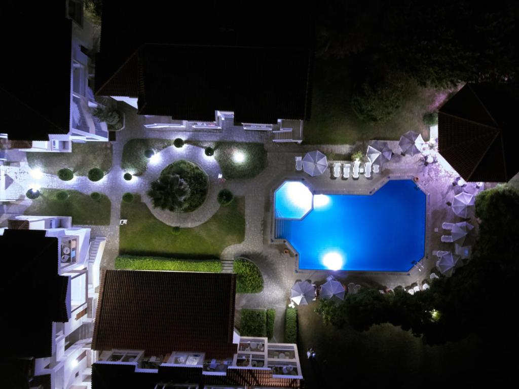 an overhead view of a swimming pool at night at Acrotel Lily Ann Village in Nikiti