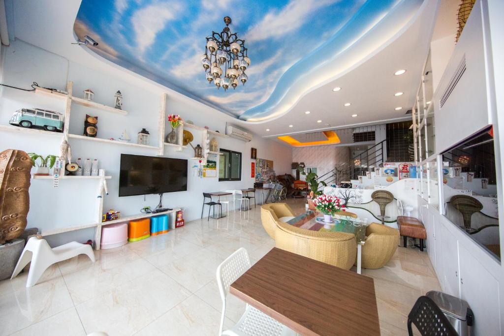 a living room with a table and a chandelier at Rococo Homestay in Hengchun