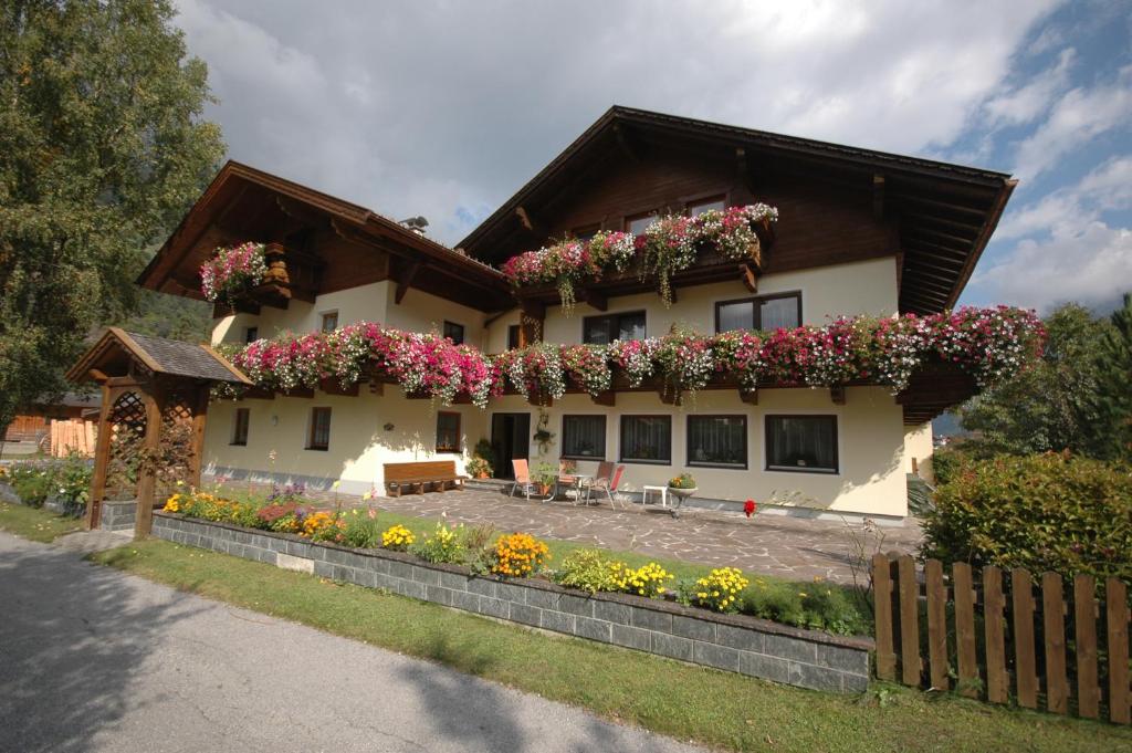a house with flowers on the side of it at Pension Nigella in Neustift im Stubaital
