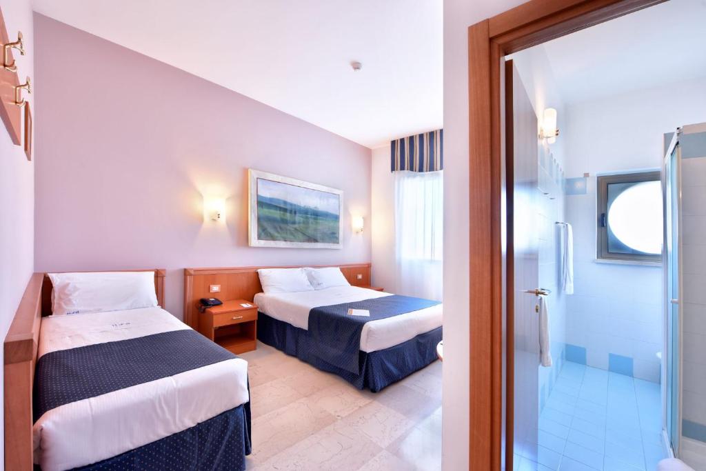 Postel nebo postele na pokoji v ubytování Hotel d'Altavilla