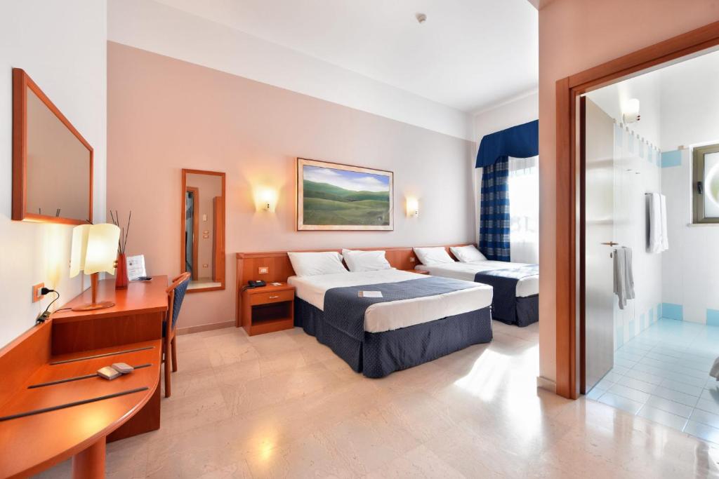 Postel nebo postele na pokoji v ubytování Hotel d'Altavilla
