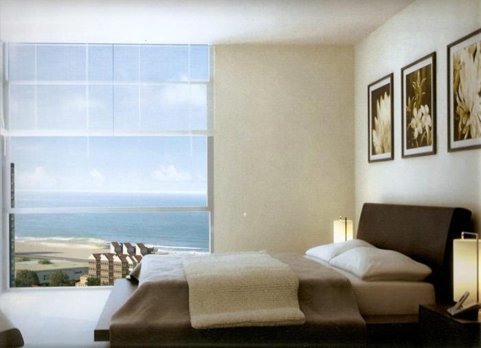 a bedroom with a large window with a view of the ocean at Forest Tower 2 in Punta del Este