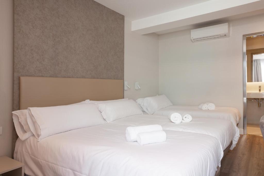 Postel nebo postele na pokoji v ubytování Hostal Centric