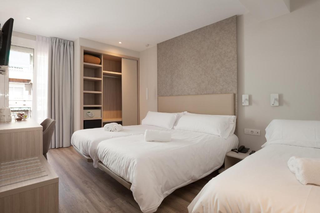 Postel nebo postele na pokoji v ubytování Hostal Centric