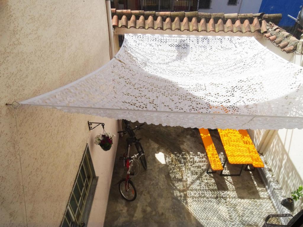 an overhead view of a white umbrella on a balcony at Buff Hostel Tirana in Tirana