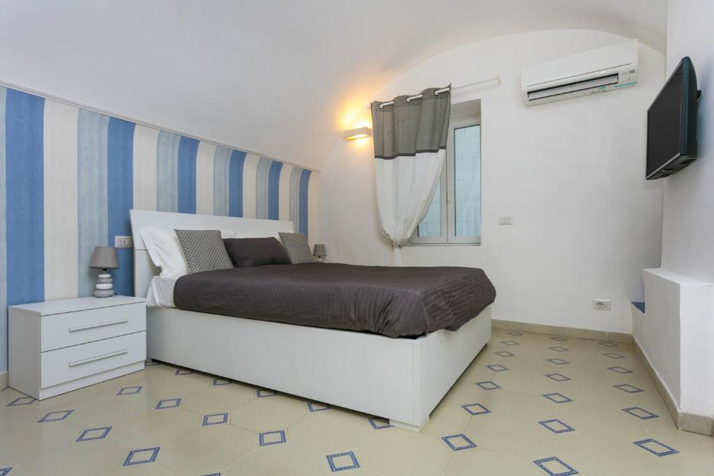 a bedroom with a bed and a television in it at To Be Capri in Capri
