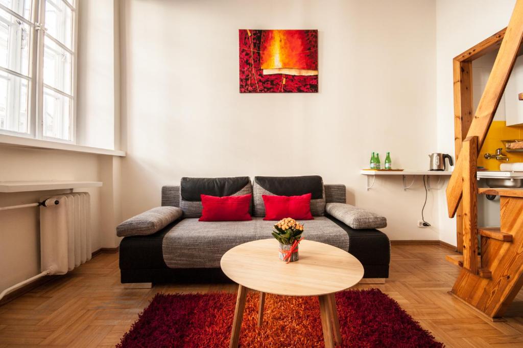 a living room with a couch and a table at Elegant Apartment Royal Castle in Warsaw