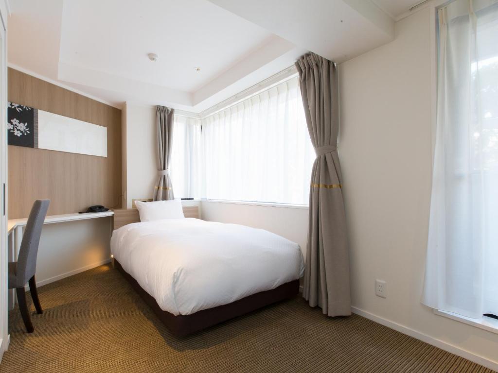 Postel nebo postele na pokoji v ubytování Hotel Shiki Utsubo Park