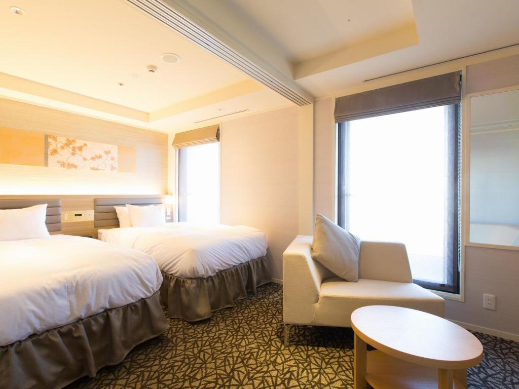 Postel nebo postele na pokoji v ubytování Hotel Shiki Utsubo Park