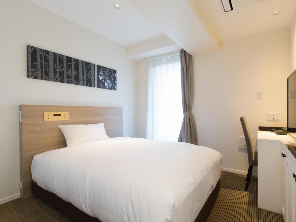 Postel nebo postele na pokoji v ubytování Hotel Shiki Utsubo Park