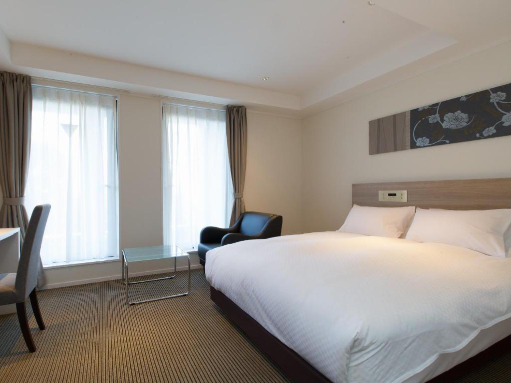 Postel nebo postele na pokoji v ubytování Hotel Shiki Utsubo Park