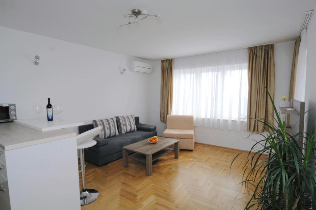 a living room with a couch and a table at Haus Zora Ferienwohnung 7 in Mošćenice