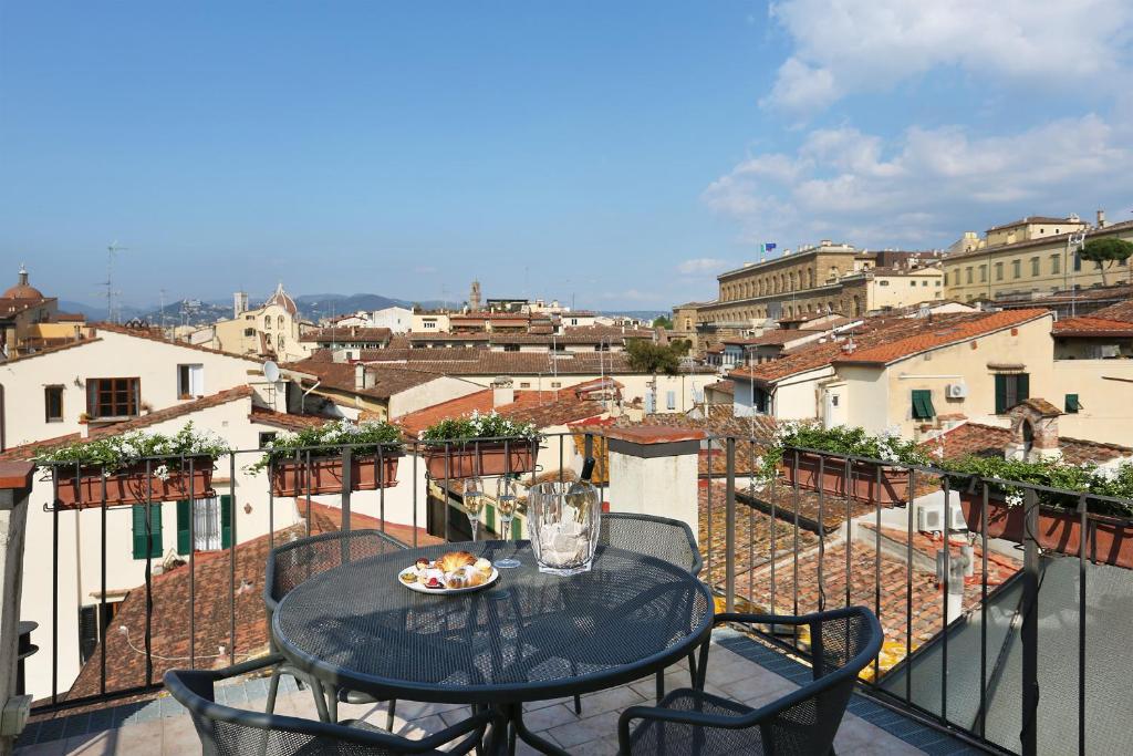 a table with a plate of food on a balcony at Borgo Tegolaio Terrace in Florence
