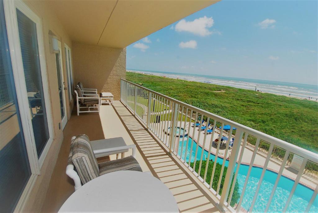 a balcony with chairs and a view of the beach at Edgewater Condo Unit #303 Apts in South Padre Island