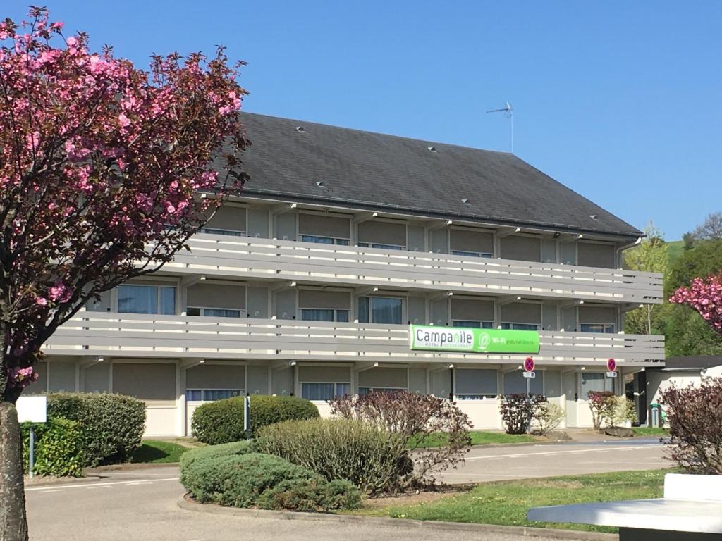 a large building with a green sign in front of it at Campanile Saint-Etienne Est- Saint-Chamond in Saint-Chamond