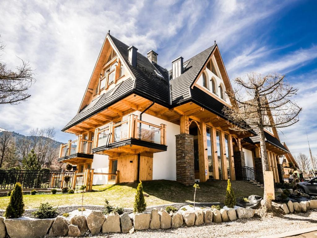 a house with a black roof at TatryTop Rezydencja Zakopiańska SPA in Zakopane