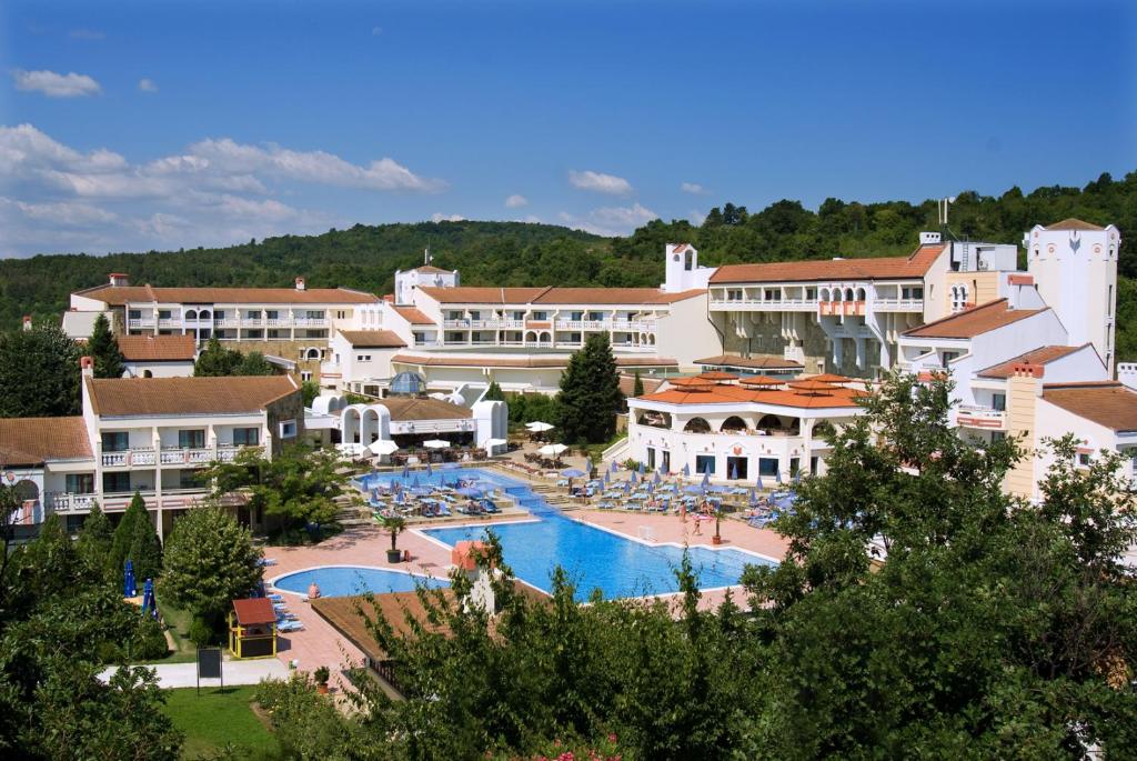 a resort with a large swimming pool and buildings at Duni Pelican Hotel - All Inclusive in Sozopol