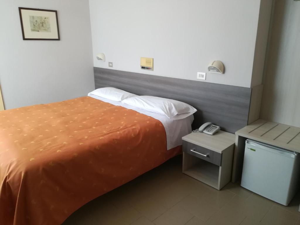 Postel nebo postele na pokoji v ubytování Hotel Saturno