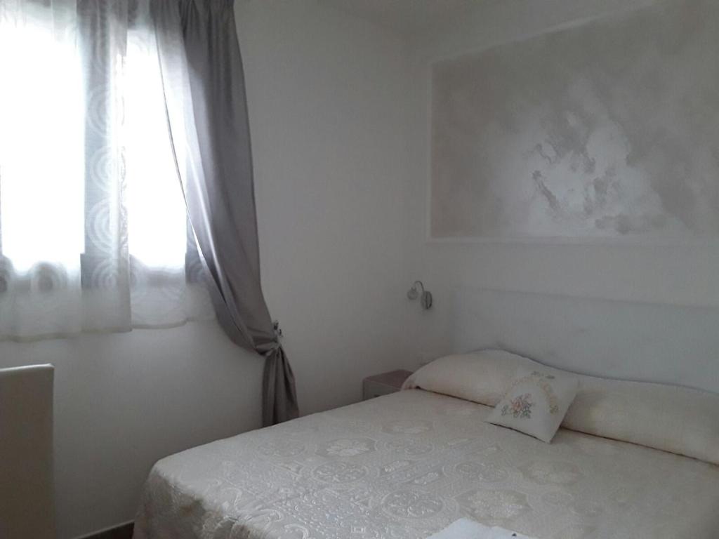 Postel nebo postele na pokoji v ubytování B&B Nonna Teresa