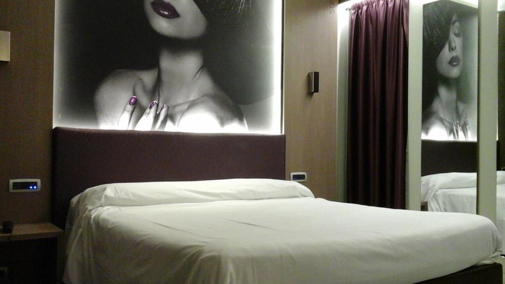 Postel nebo postele na pokoji v ubytování Hotel Camelia