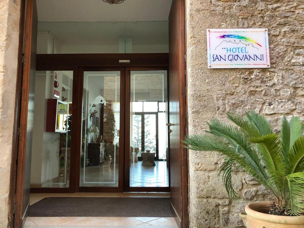 a hotel entrance with a sign on a building at Hotel Villa San Giovanni in Erice