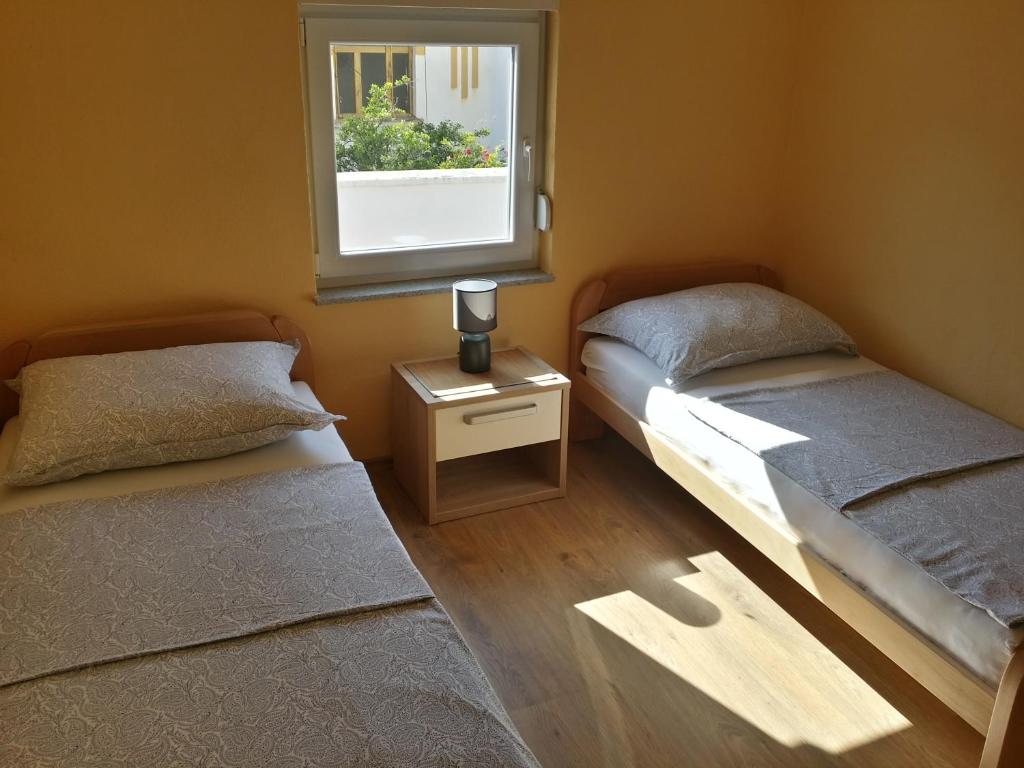 Postel nebo postele na pokoji v ubytování Apartments Uno