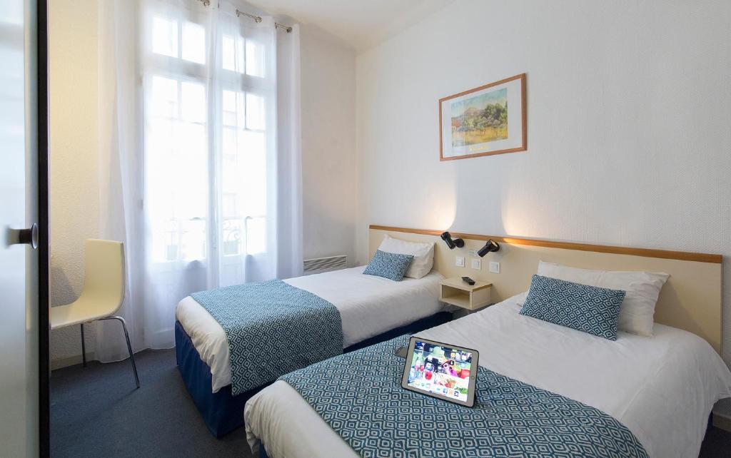 Postel nebo postele na pokoji v ubytování Hôtel Aneto