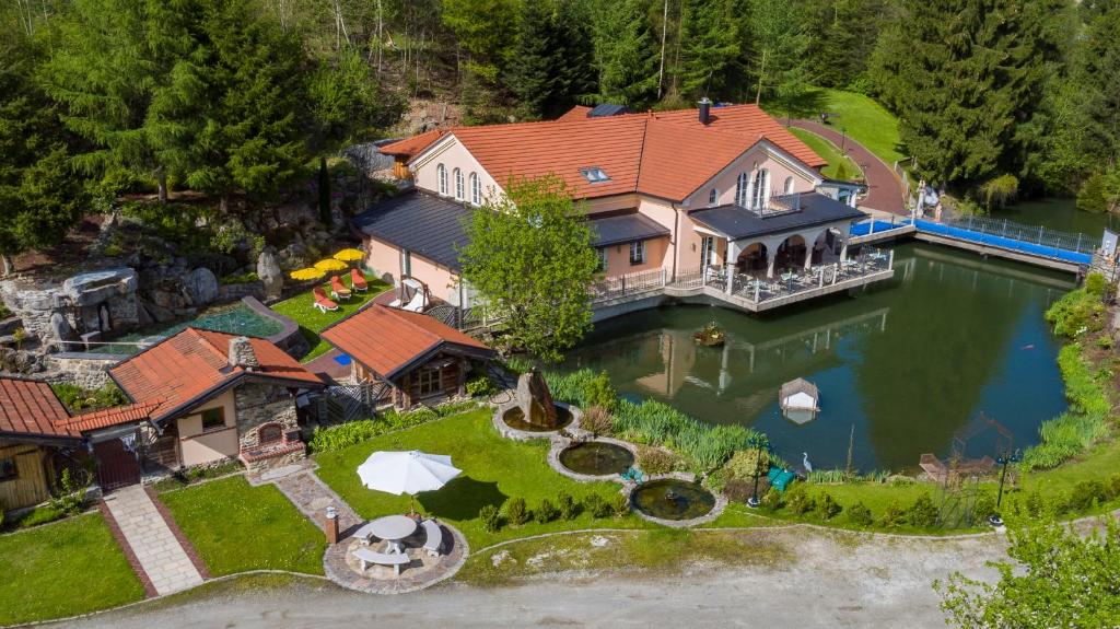 an aerial view of a large house on the water at Wellness Resort Romantika in Hauzenberg