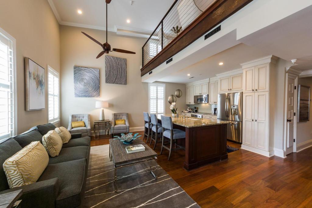 a living room with a couch and a kitchen at The Quarters on King in Charleston