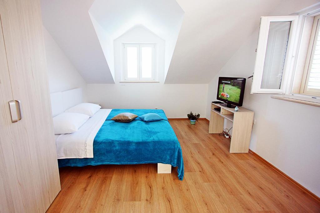 Postel nebo postele na pokoji v ubytování Apartmani Nila