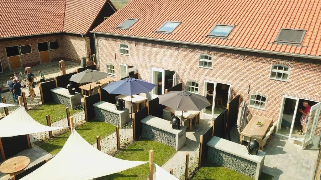 an overhead view of a building with tables and umbrellas at 't Veldehof in Domburg