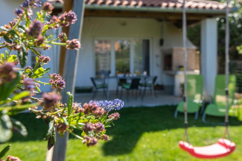 a house with a yard with a swing at Apartment Green Garden in Pula