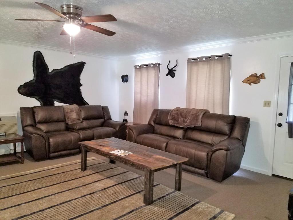 a living room with a couch and a coffee table at KY Lake Area Cabin in Aurora