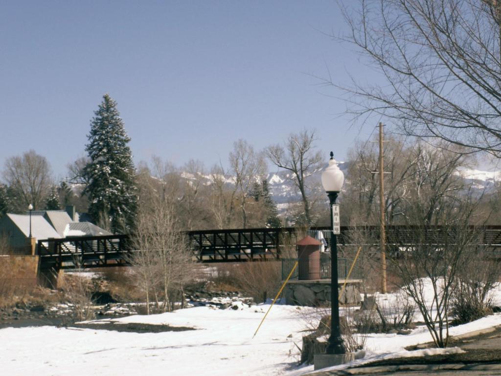 a street light in the snow with a bridge in the background at Healing Waters Resort and Spa in Pagosa Springs